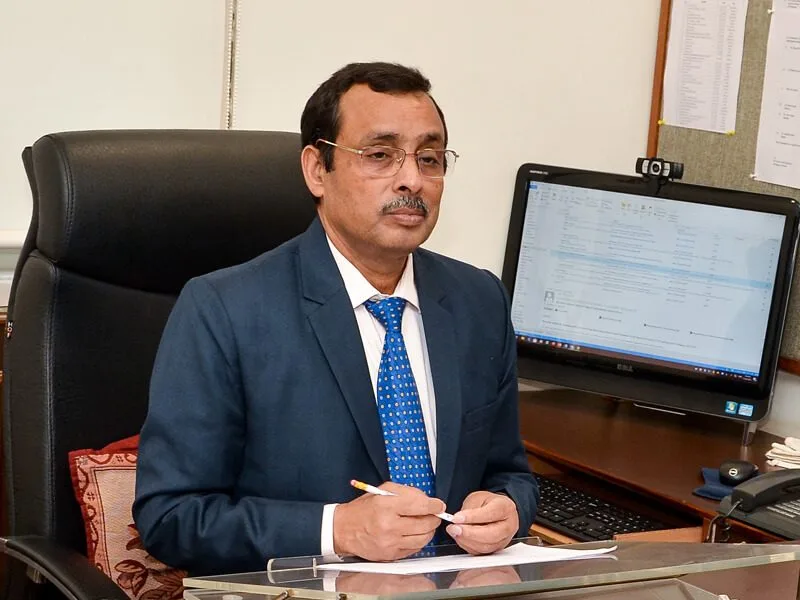 Portrait of Dr Sunil Shukla at his office desk