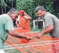 Artisans working with handloom textiles outdoors