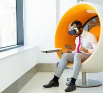 Person using virtual reality in a modern pod chair