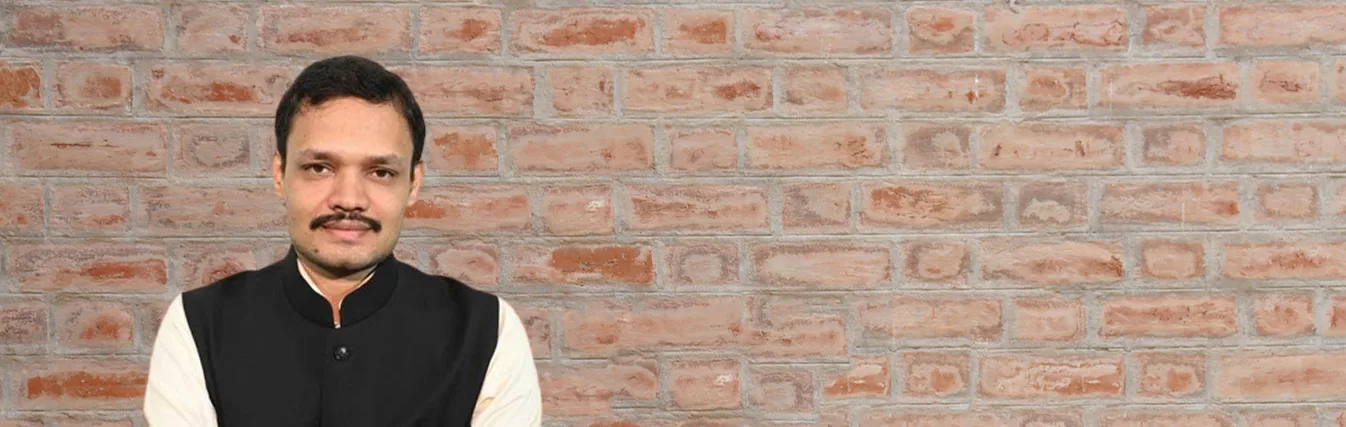Portrait of a faculty member in a dark waistcoat