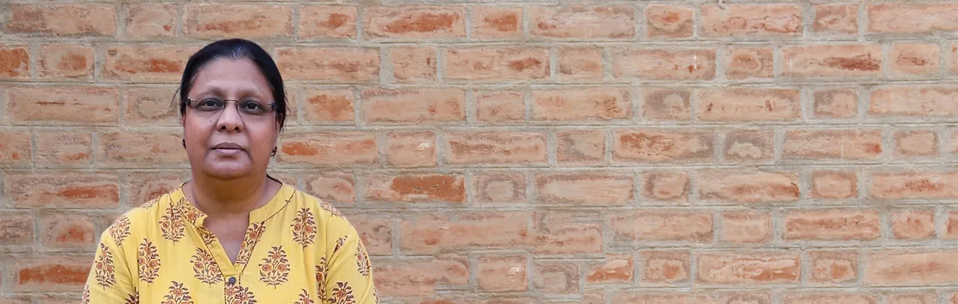 Portrait of a woman faculty member in a yellow outfit