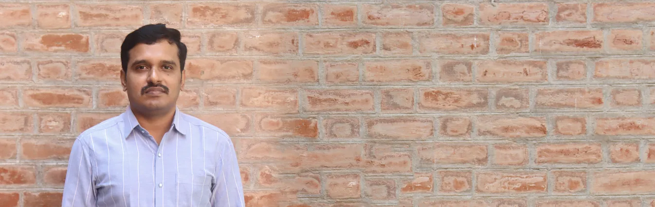 Portrait of a faculty member in a blue shirt