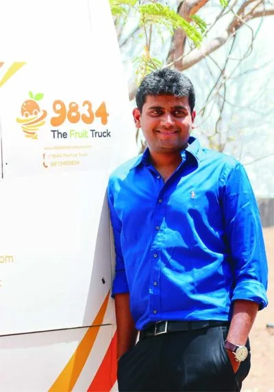 Man in a blue shirt standing at a startup stall