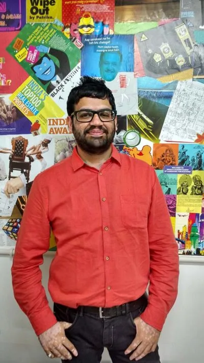 Man in a red shirt with a photo collage background