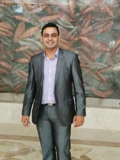 Man in a grey suit posing