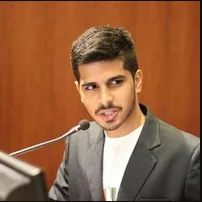 Young man in a blazer at a podium