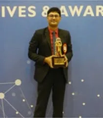 Nimesh Pithava holding an award