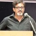 Man with a beard speaking