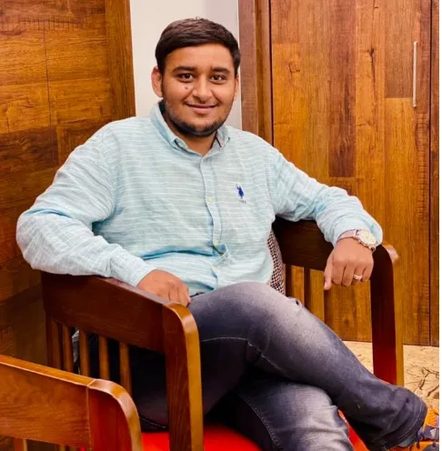 Young man in a checked shirt seated