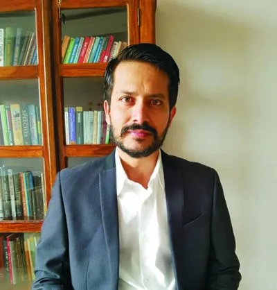 Portrait of a man in front of a bookshelf