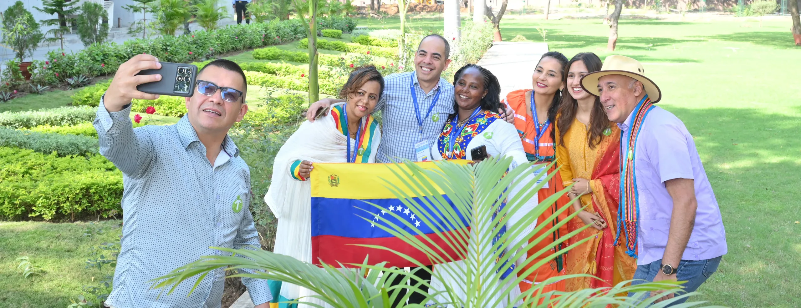 International participants group photograph with a flag